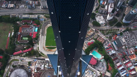 drone flying down along the merdeka 118 tower, in sunny kuala lumpur, malaysia