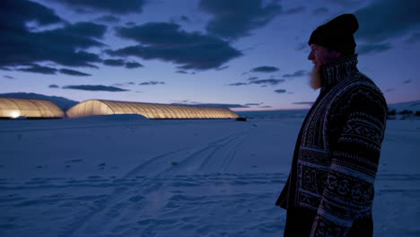 man at a greenhouse farm in winter