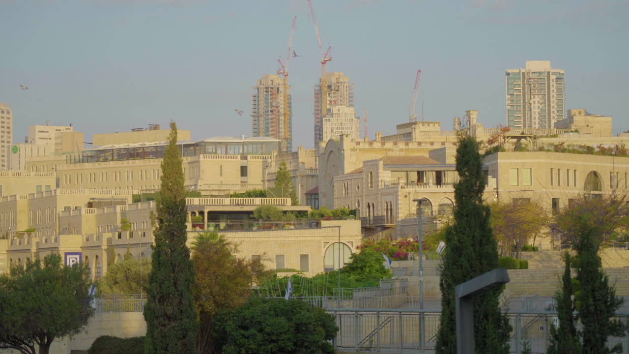 Slow Motion of Birds Flying Overlooking Jerusalem Skyline and Construction during Sunrise