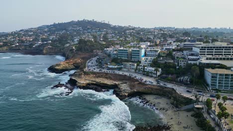 a drone shot of the picturesque la jolla beach coastline in california, featuring stunning ocean views and rugged cliffs.