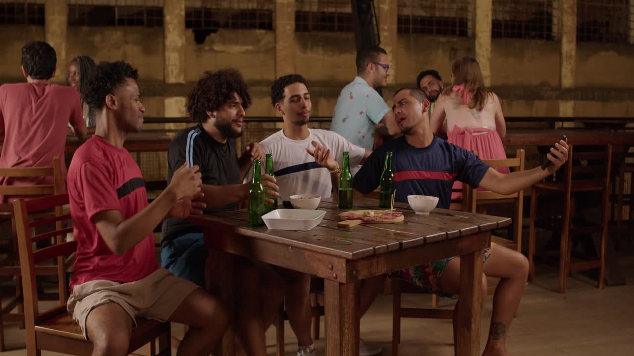 Friends Enjoying Drinks and Taking Selfies at a Bar