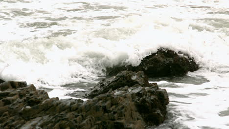 waves covering rocks at the coast