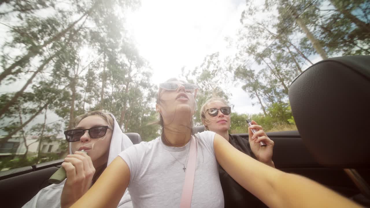 Women Vaping in Convertible on Road Trip