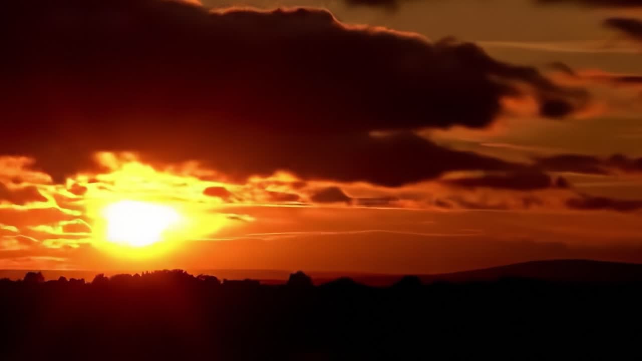 Breathtaking Sunset Over Rolling Hills: A Spectacular Display of Nature's Palette with Fiery Hues of Orange, Red, and Yellow Painting the Sky