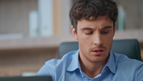 Closeup tired employee working laptop in office. Hands making notes at buro