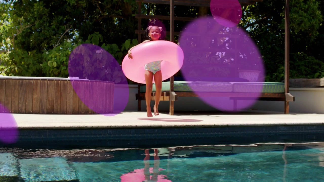Girl holding pink ring by pool, motion starting, pink circles drifting over her, prepping for play