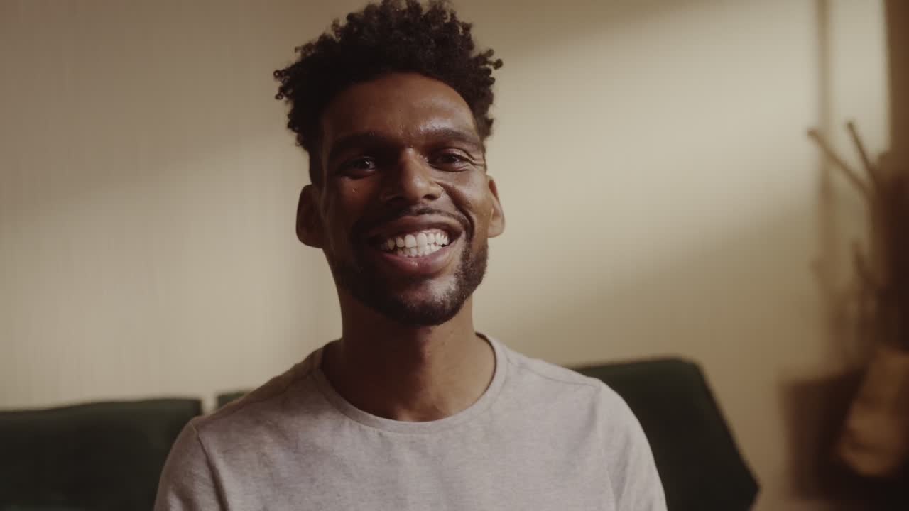 Close-up of a young African American man smiling at the camera