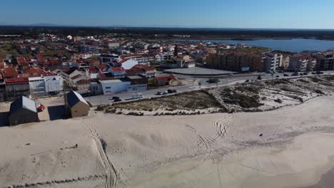 aerial flyover sandy beach and coastal city of praia de mira in portugal during sunny day