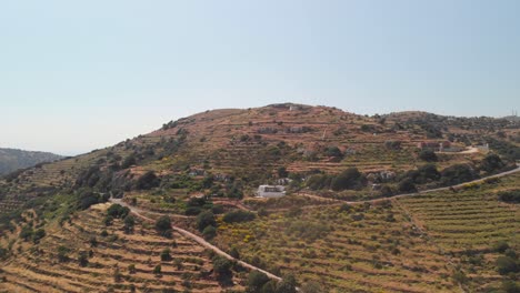 Right-rotating-Aerial-over-beautiful,-typical-mediterranean-landscape-with-roads,-olive-trees-and-houses