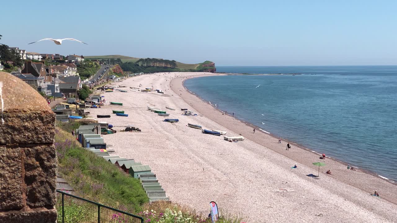 Scenic Beach View with Boats and Beach Huts