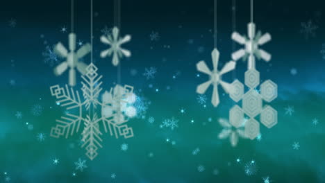 animation of christmas baubles and snow falling on blue background