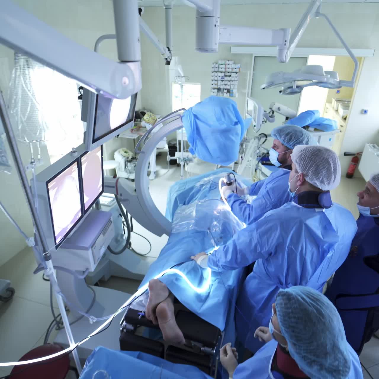 Doctors using laparoscopic equipment. Surgical operation with laparoscopic equipment in surgery room