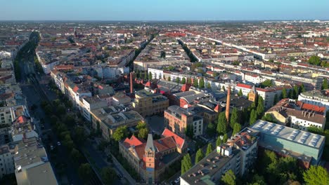 berlin's urban landscape, capturing a mix of residential and commercial buildings, streets, and green spaces. stunning aerial view flight descending drone