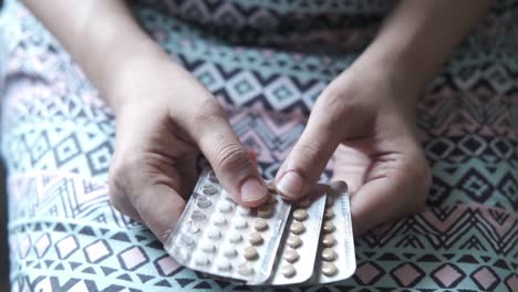 woman holding birth control pills