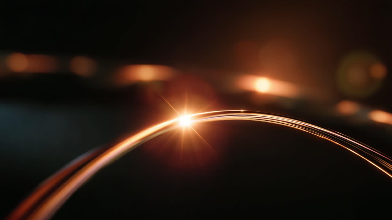 A Glimmering Arc of Light Emphasizing Radiance and Motion in an Intimate Close-Up of Glowing Linear Elements Against a Softly Blurred Background