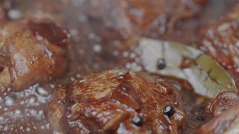 filipino-adobo-chicken-thighs-and-chicken-legs-simmering-in-dark-glaze-sauce