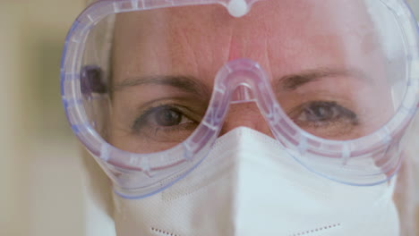 close-up shot of cheerful doctor in protective spectacles