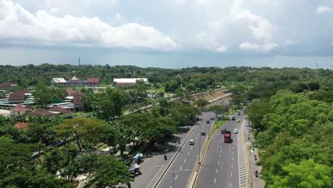 Beautiful-drone-heading-to-Bangkalan-Regency,-Madura-Island-with-busy-community-traffic-on-Madura-Island,-East-Java,-Indonesia