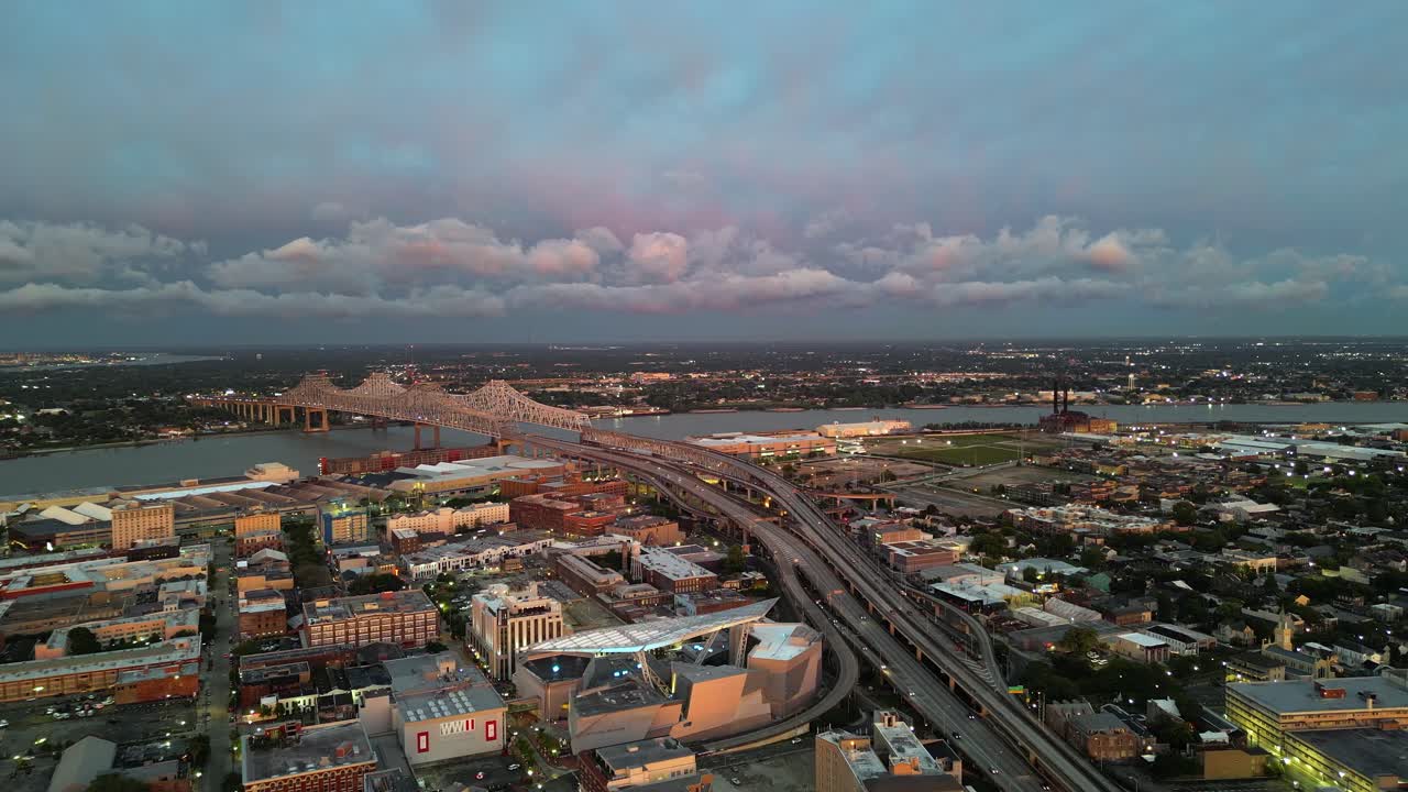 Golden hour flyover: New Orleans Crescent City bridge on Mississippi R