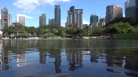 reflection of urban buildings in the water on bright blue sky