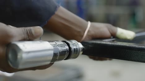 close up slow motion drilling into a metal frame