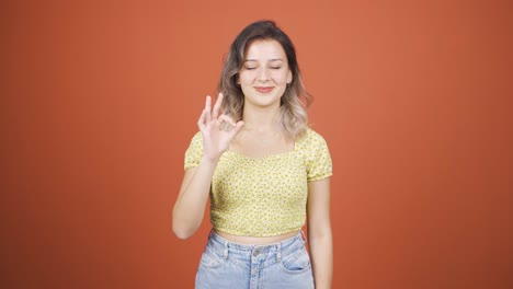young woman making positive gesture at camera.