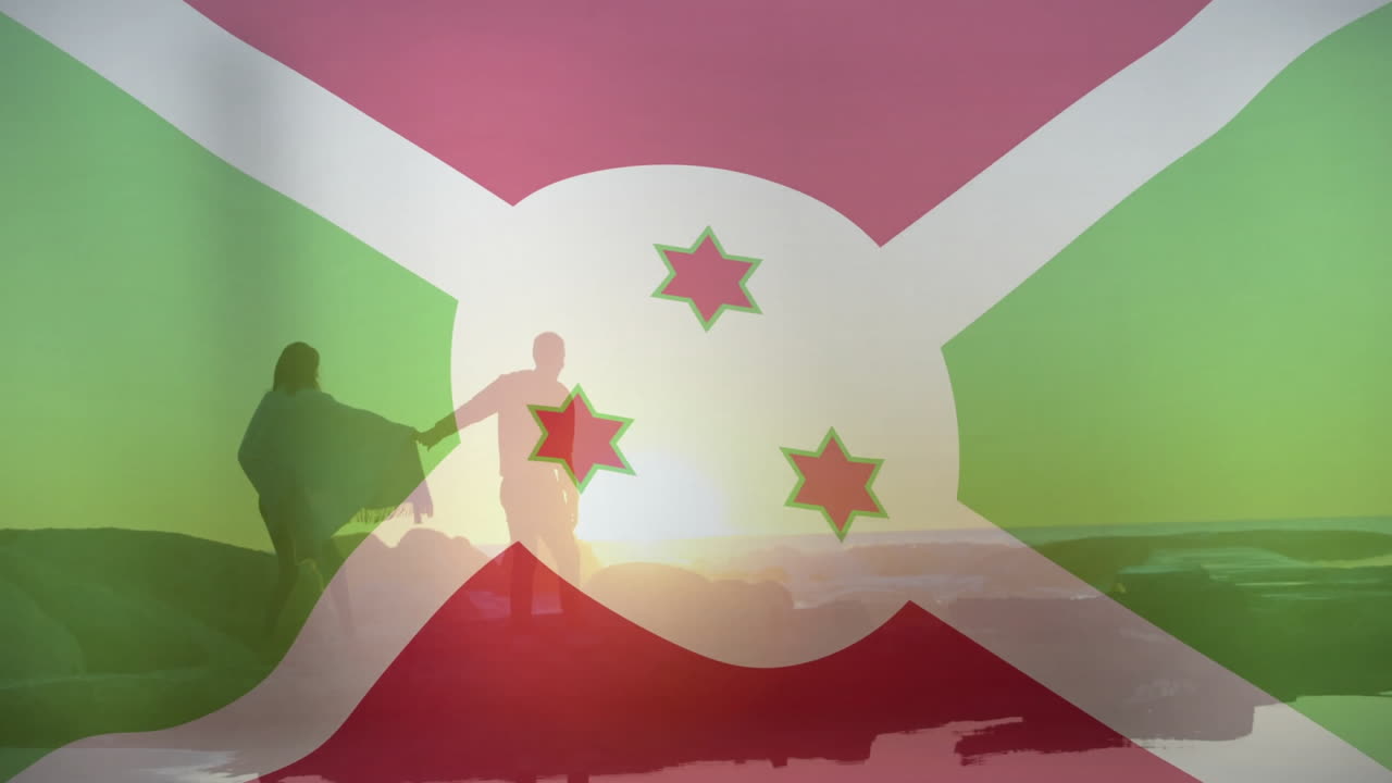 Holding hands over Burundi flag, people in silhouette against sunset animation
