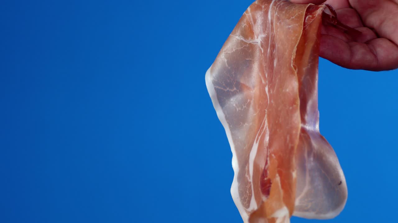 The man's hand holds the antipasto.