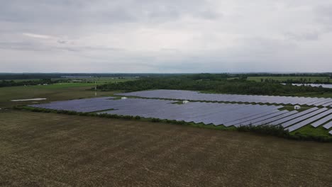 Solar-Power-Station-On-A-Cloudy-Day---aerial-drone-shot