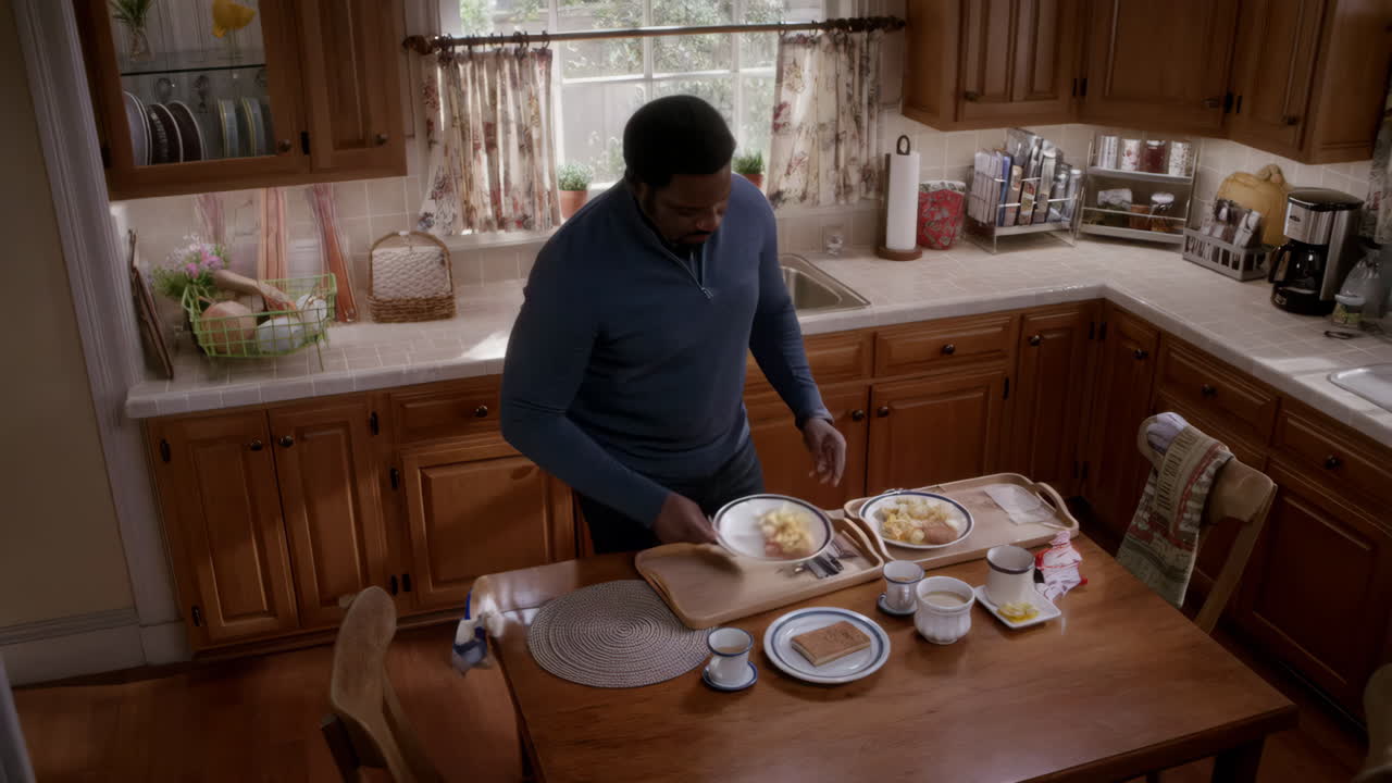 A man is preparing breakfast in a kitchen