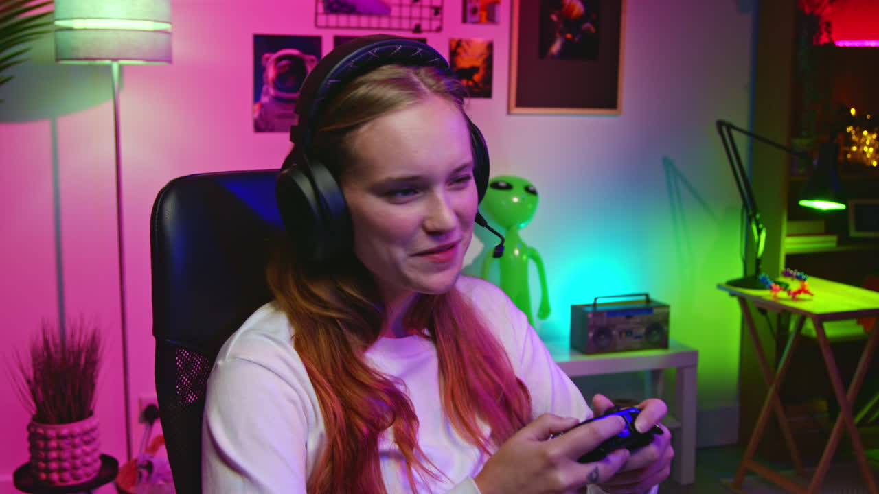 Woman playing video games in a pink room