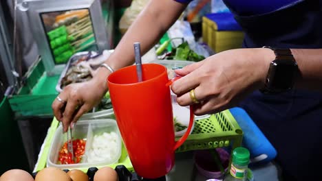 vendor preparing food with fresh ingredients