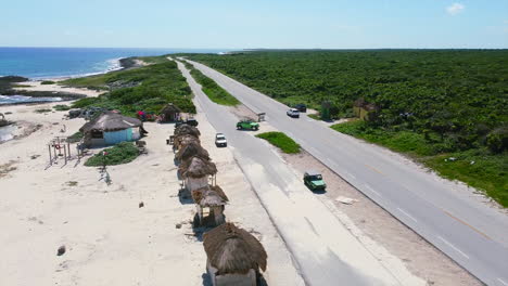 coastline road with tourist beach shops on sunny day in cozumel mexico