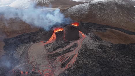 scenic view from above of erupting volcano with hot lava flowing from crater