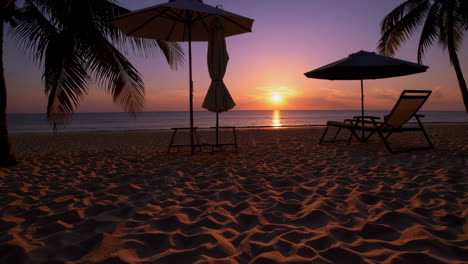 Tropical Beach Sunset with Palm Trees and Beach Umbrellas