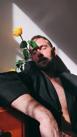 man with yellow roses in sunlight