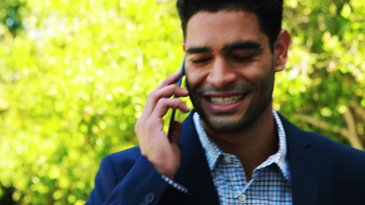 Businessman talking on mobile phone 4k