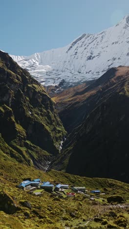 remote village and mountains in nepal, vertical hiking teahouse in himalayas mountains, vertical video for social media instagram reels and tiktok of teahouses accommodation on annapurna circuit hike