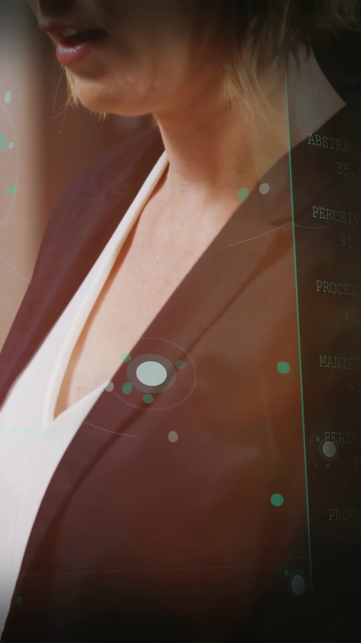 Vertical video: Business woman presenting while HUD growing and camera rising revealing data panel