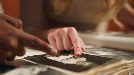 white lady with african-american boyfriend looks at album