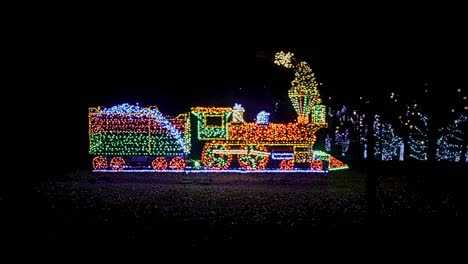 a view of an led steam train as a christmas display with moving wheels and smoke