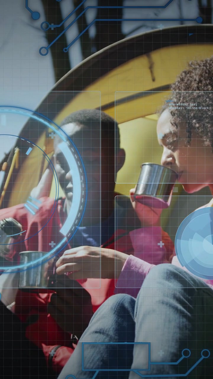 Vertical video: Man stirring pot, leading woman sharing drink, HUD aligning over cups at camp