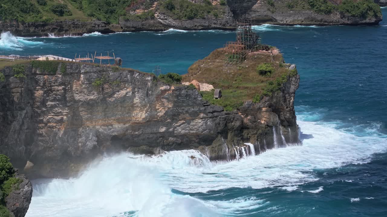 Drone footage flying towards powerful ocean waves crashing on rocky cliffs, Nusa Penida