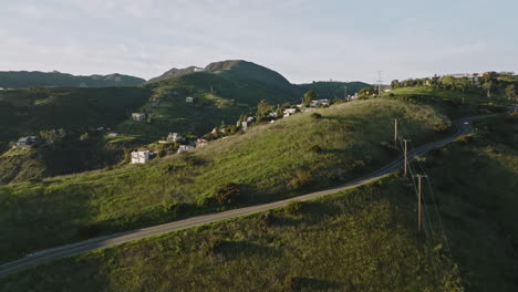 aerial drone shot flies over malibu mountain to reveal houses and mansions in the hills