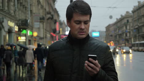 man using smartphone on the street