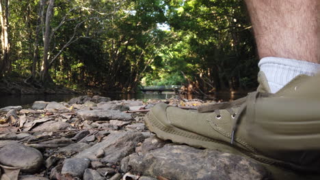 closeup of foot walking in front of a camera on a rocky pathway