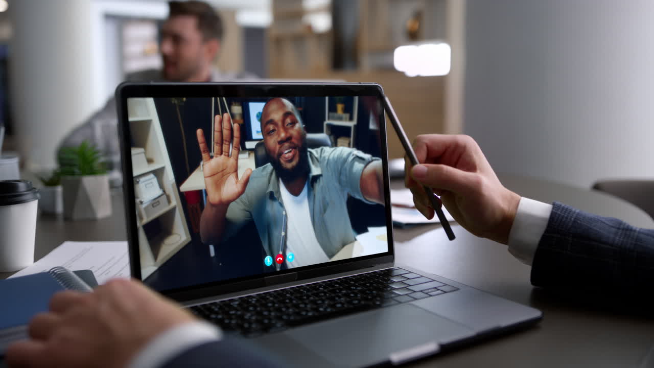 Smiling coach greeting webcam laptop having virtual meeting businessman close up