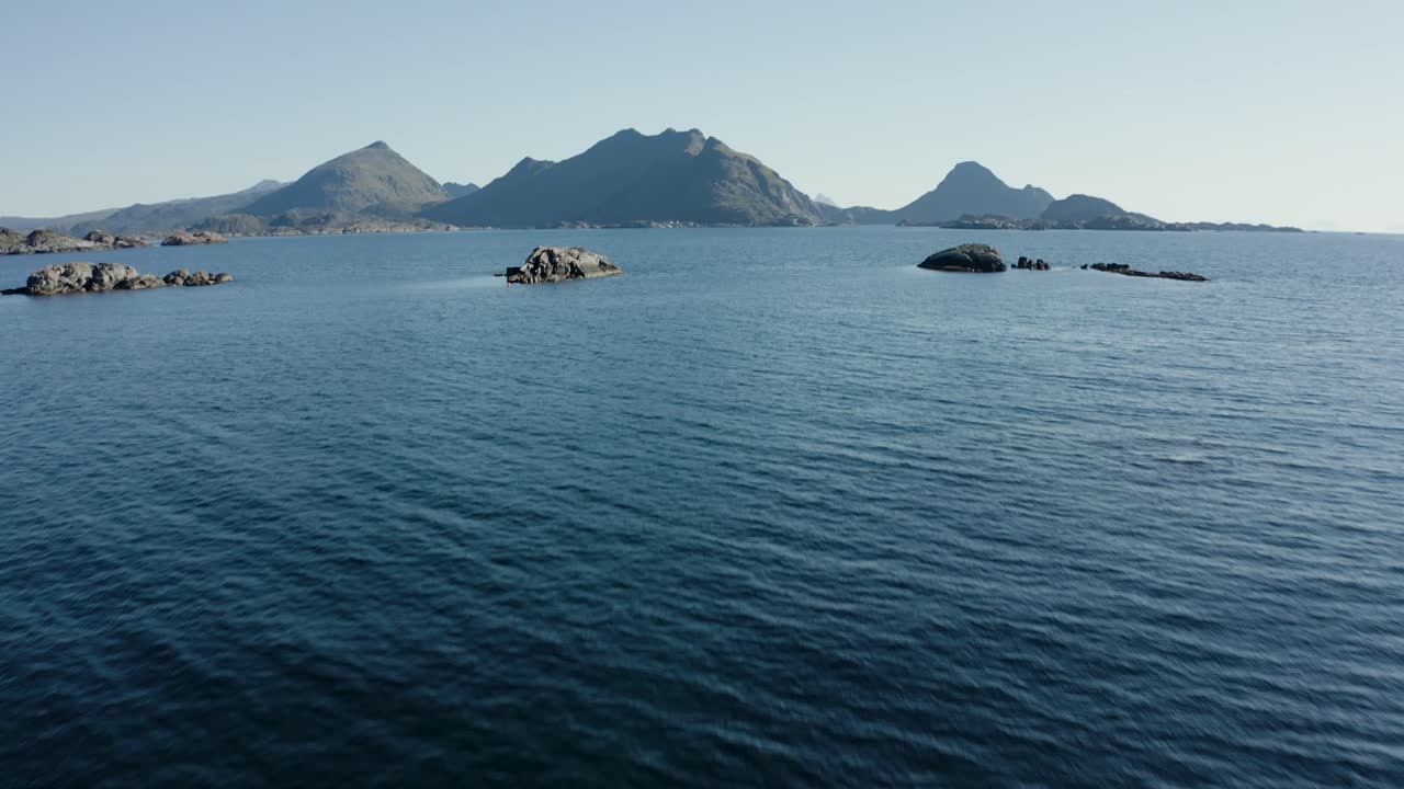 Aerial drone shot of scandinavian landscape with dramatic mountains and ocean