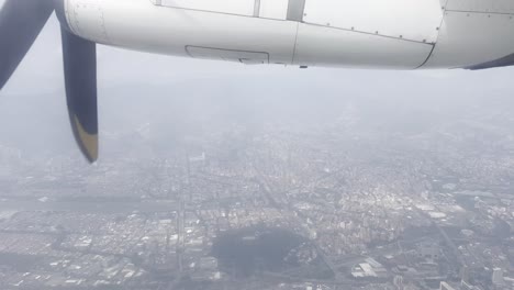 View-out-of-the-window-of-a-small-airplane-leaving-domestic-airport-Olaya-Herrera-in-the-city-center-of-Medellín-in-the-Antioquia-department-in-Colombia