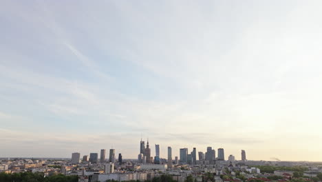 warsaw skyline with high-rise and skyscrapers at sunset in poland. - tilt down shot